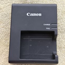 black Canon LC-E10 battery charger.