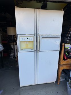 Refrigerator white GE Profile side-by-side refrigerator, specifically a mode