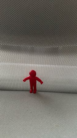 Small Red Plastic Human Figure Token