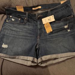 Women Levi mid-length blue jean shorts size 33. Brand new with tags