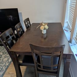 Ashley's 6 seater Dining table with 4 chairs and a bench