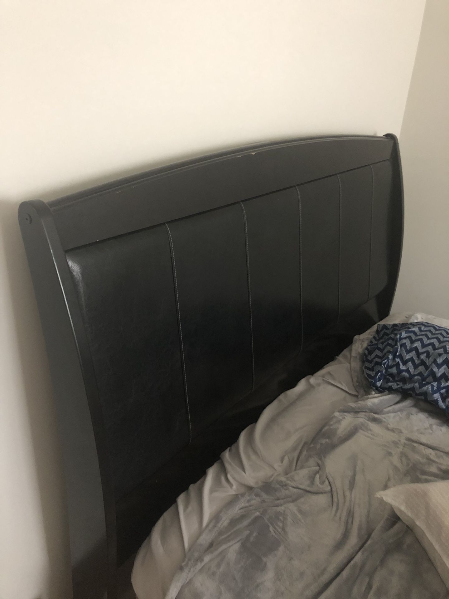 Queen bed head board with mattress and box spring.