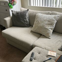 White Sofa With Grey And Blue Accents.