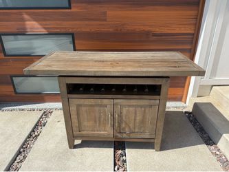 Expandable outdoor table with built in storage and wine rack.