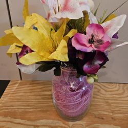 Beautiful clear unique glass vase with silk fabric flowers that I made into a flower arrangment as a table decor

Please go to my page and see other i