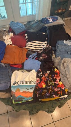 Table Full Of Woman Clothes