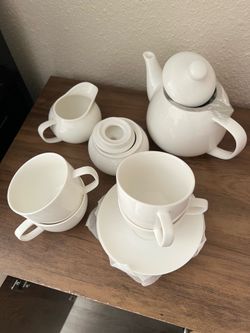 White Ceramic Tea Set with Teapot, Cups, and Saucers