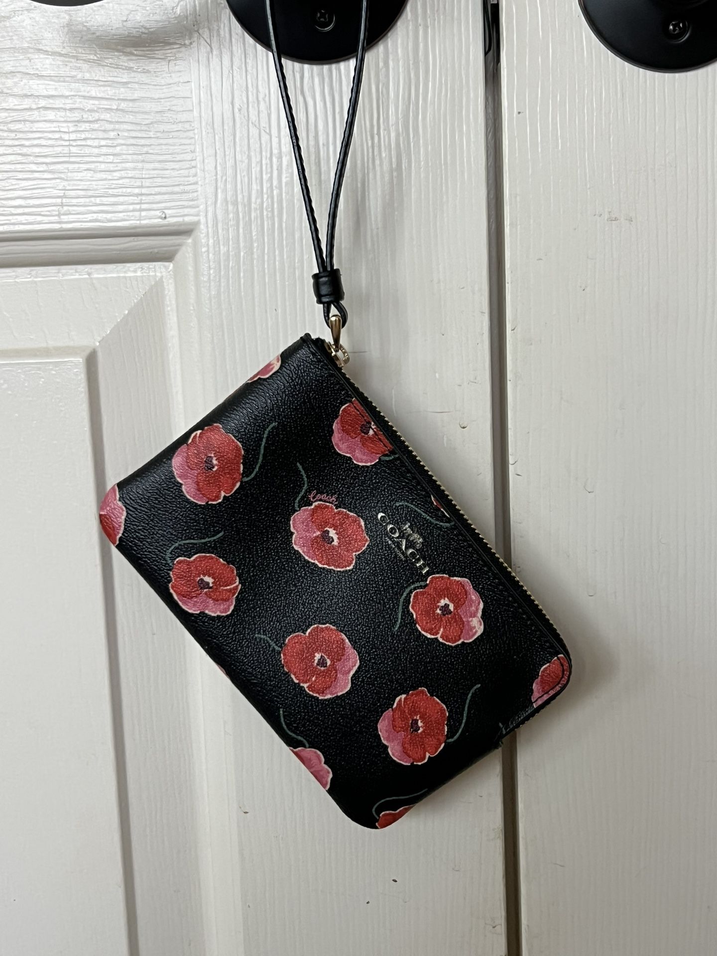 Coach Wristlet with flowers in like new condition.