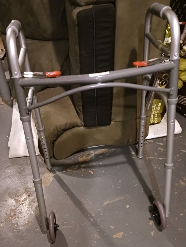 NEW WITH TAGS DRIVE BRAND DUAL RELEASE FOLDING WALKER W/ 5 INCH WHEELS, 2 BUTTONS, ADJUSTABLE HEIGHT