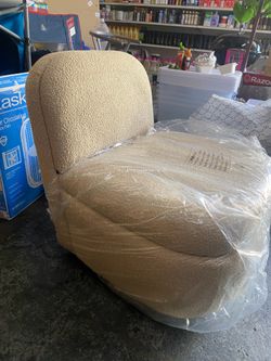 Cream-colored rotating sliding armchair