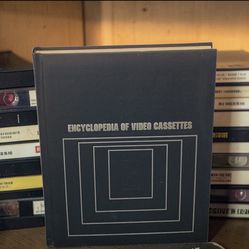 1986 Encyclopedia of Video Cassettes - The Video Cassette Library Hardcover Book. The back has a blemish, as shown in the pics. This item is a copy of