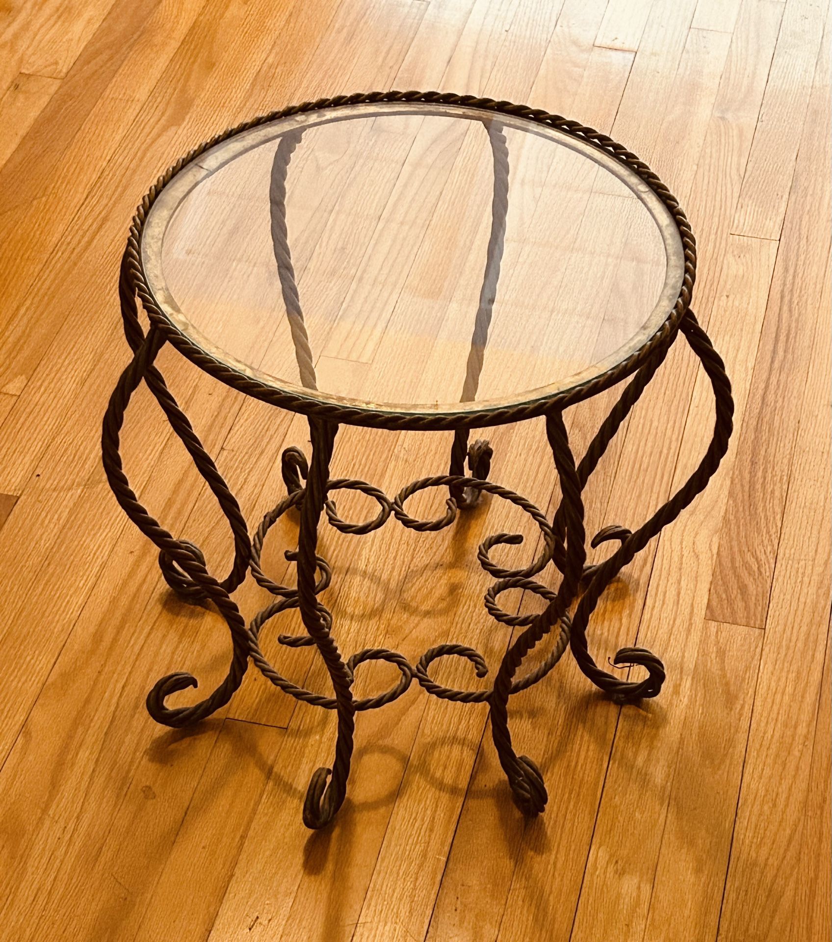round metal side table with glass top.
