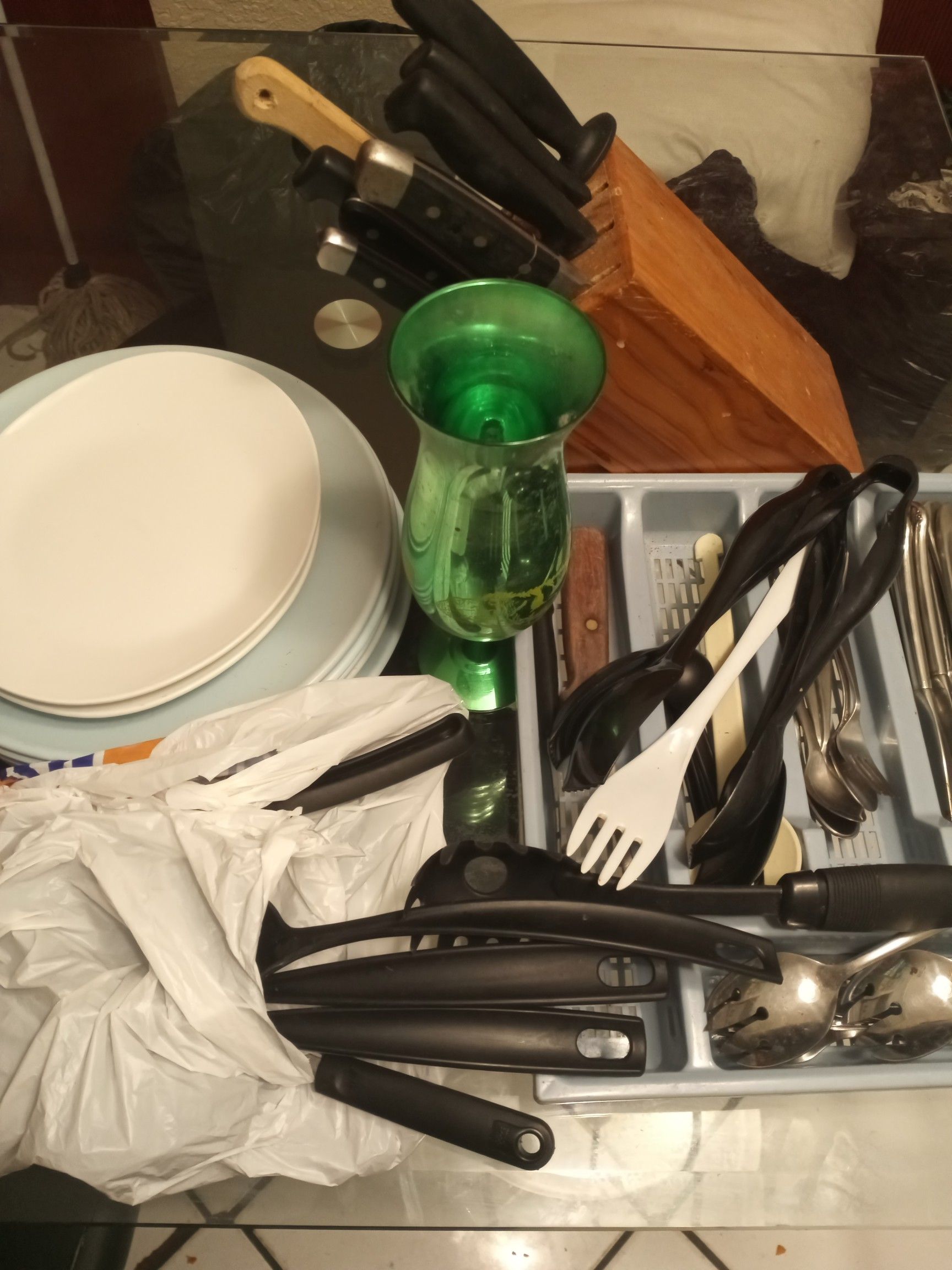 Assorted plates cooking utensils
