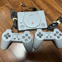 Sony PlayStation With Controllers And Games 