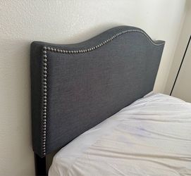 Dark gray upholstered arched headboard