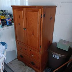 A Brown Wood ARMOIRE, Two Metal Shelves, and a Metal Work Bench.
