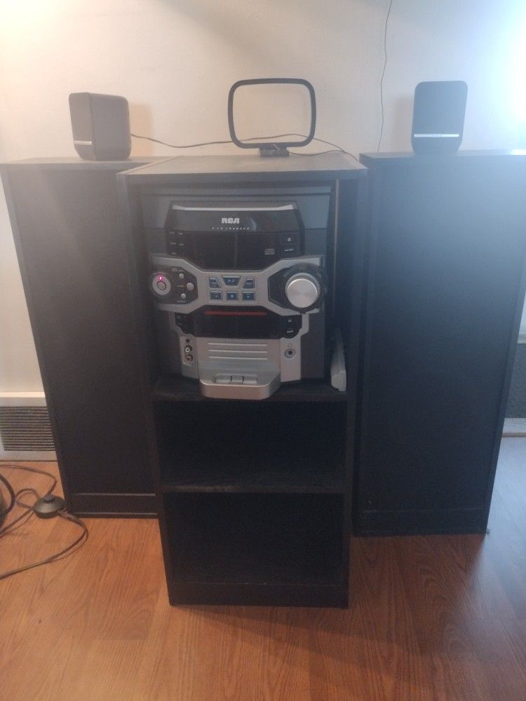 RCA Stereo system with remote, speakers and shelves.