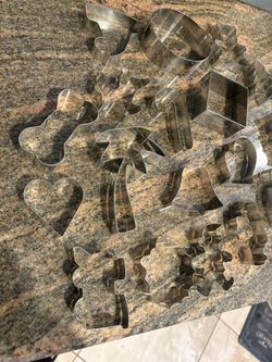 32 Cookie Cutters. Good condition. Tin box included 