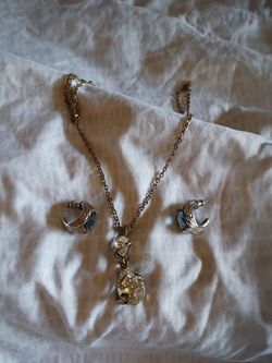 Women's crystal and silver snake charm necklace and earrings.