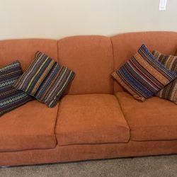 Orange Couch With Boho Pillows $100