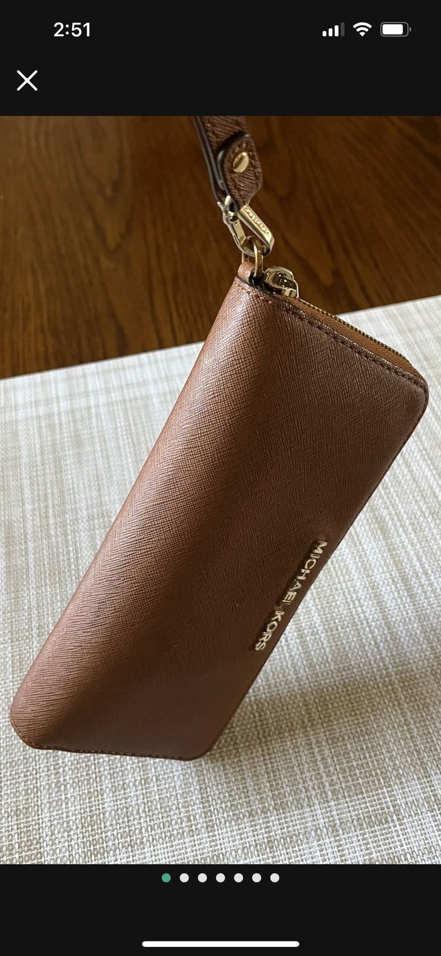 It’s A Michael Kors Wristlet Wallet It’s Barely used the color is brown