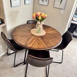 Ashley’s Centiar Round Dining Table with Hairpin Legs and matching Bucket seats  