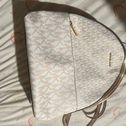 Michael Kors Sheila Medium Two-Tone Signature Logo Backpack in rose gold.