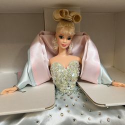 1997 Billions of Dreams Limited Edition Barbie doll by Mattel.  The doll wears an icy blue satin gown embellished with sparkling "jewels".  It feature