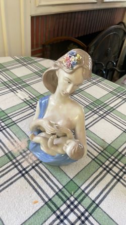 Porcelain mother nursing baby figurine