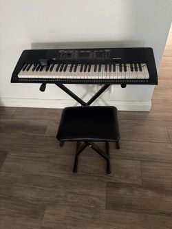 Keyboard with stand and chair.