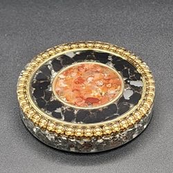 HandMade Thick Coaster Orgonite, With Carnelian, Black Obsidian, and Clear Quartz crystals.

Weighs 10 oz

3/4" H

Diameter is 3-3/4"


Contains:


Ca