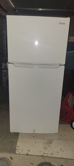 Brand new fridge with top freezer.