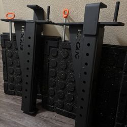 SML-1 Rogue 70” Squat Rack With 2 Storage Pegs For 2” Weights Safety Spotter Arms Included With Pins.  NOTE: J - Hooks Are Not Included Only Spotters