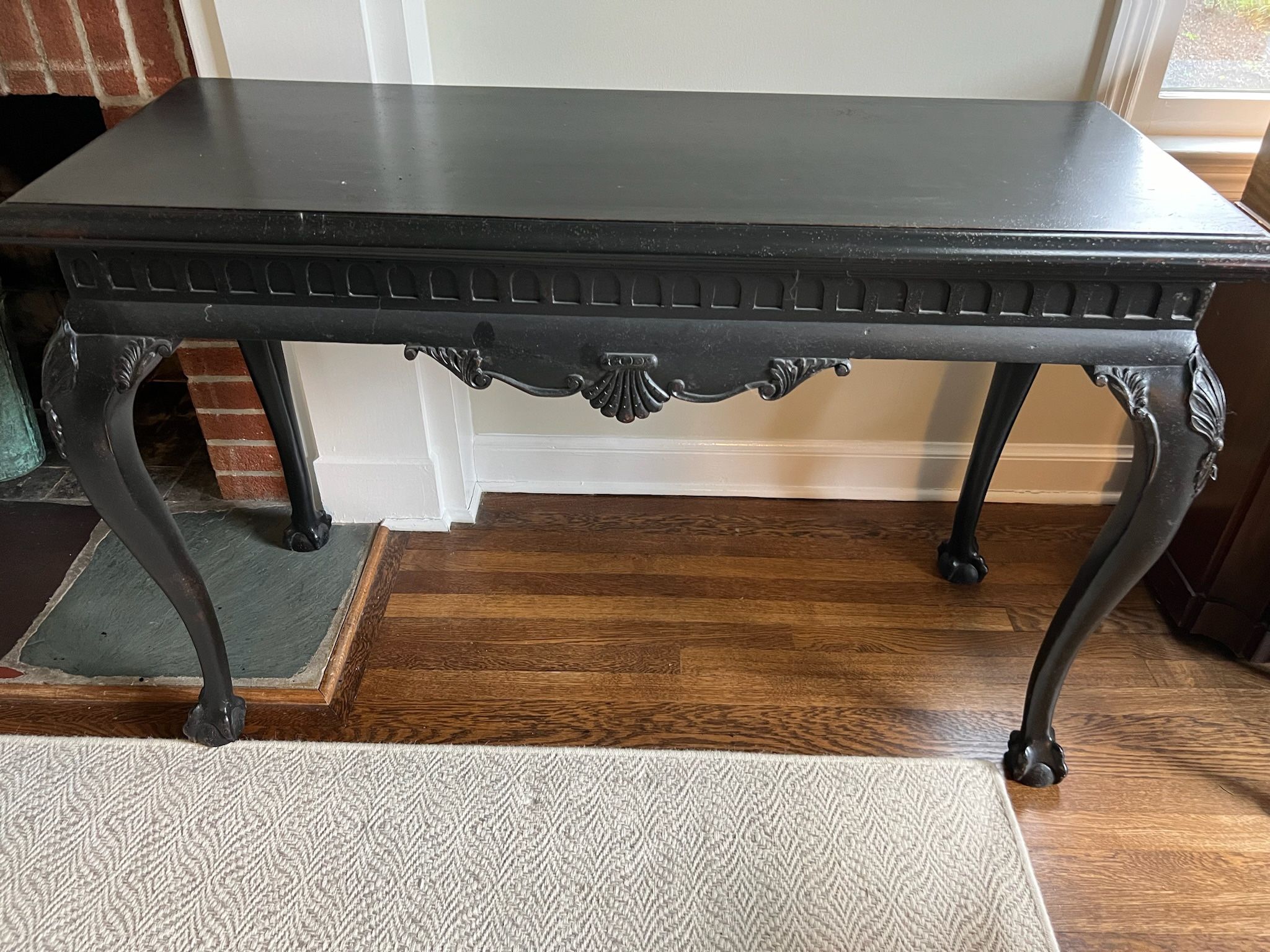 Black Distressed Console Table in Very Good Condition Shell detailing and claw feet. Measures 20”d x 50”w x 32”h. Smoke and pet free household