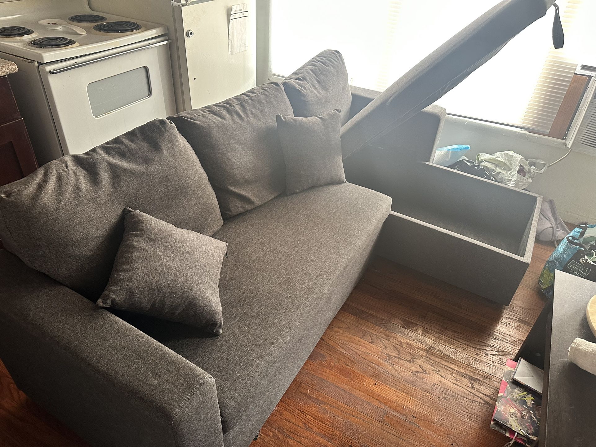 Grey L Shaped Couch w/ Storage. Bottom Pulls Out Into Queen Bed for