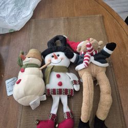 Two christmas stuffed snowman and one stuffed Reindeer
