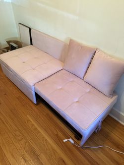 Pink futon chair with pillows