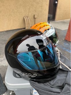 This black Shoei RF-700 motorcycle helmet features a distinct blue-tinted visor.