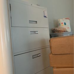 Four drawer gray file cabinet in working order