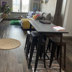 Grey industrial wooden dinning island with stools