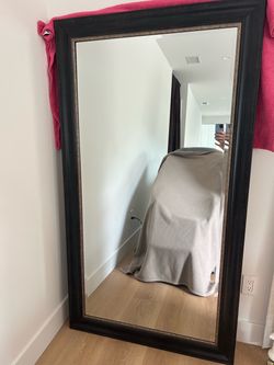 Large dark framed floor mirror