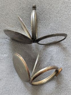 Old antique 925 and .800 SILVER pocket watch cases. Late 1800s or early 1900s. Selling as-is. 63 grams or 2.3 ounces. 

See my other items and make me