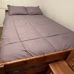 Full-size bed with pullout twin bed and two built in drawers.