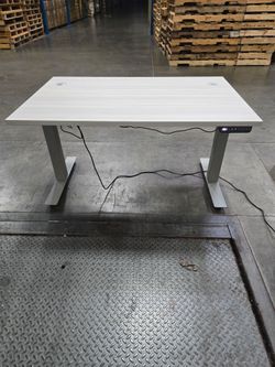 Height adjustable desk top