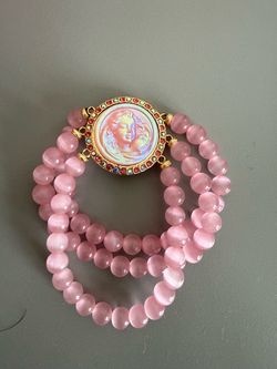 Kirks folly women’s Multi-strand pink bead bracelet with angel centerpiece