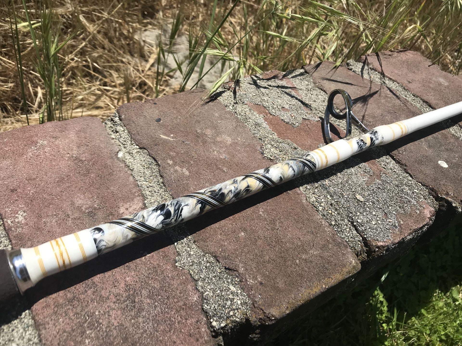 holding a fishing rod Here Is Where To Grip A Spinning Rod During The Retrieve