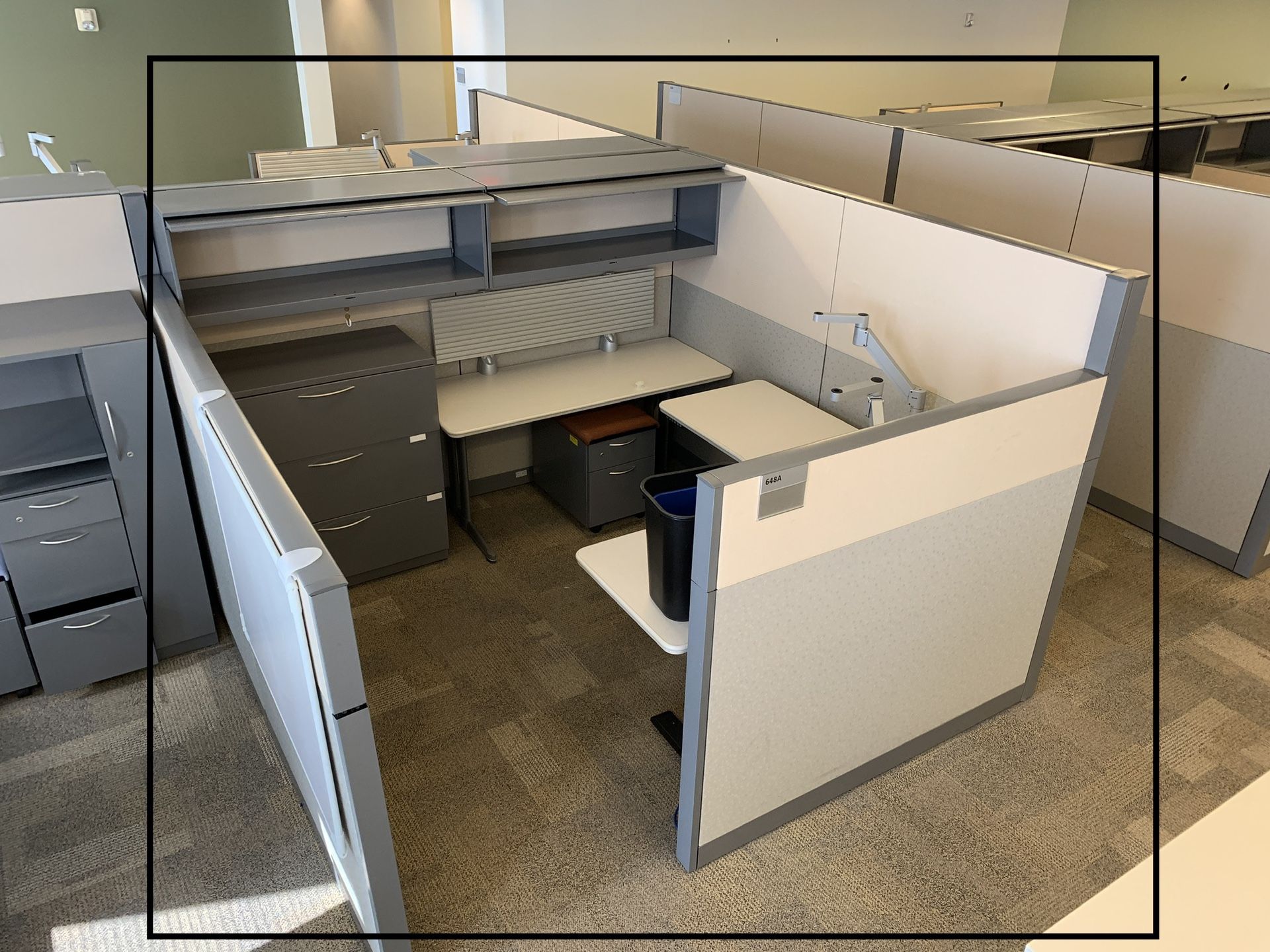 One cubicle, one adjustable electric L table, 3 drawer file cabinet, two drawer wall Cabinet, small two drawer roll up cabinet.