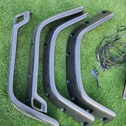 black fender flares for a Jeep Wrangler TJ, likely from the 1(contact info removed) model years. 