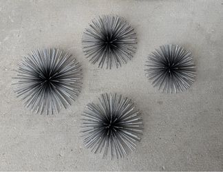CosmoLiving by Cosmopolitan metal 3D starburst wall decor sculptures.