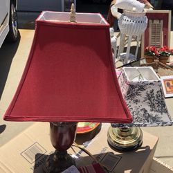 Lamps 2 Different Ones 1 Red With Brown  base And One Smaller One In Black With Tapestry Shade 